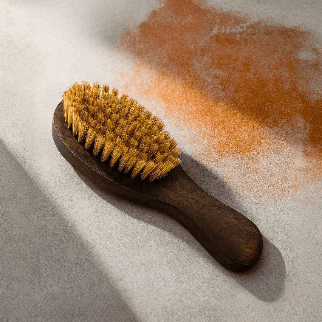 Wooden brush with bristles on a textured surface